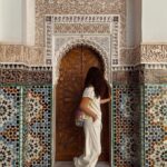 A young lady exploring the stunning Islamic architecture at the Medersa Ben Youssef during an epic Morocco group trip young travelers love.