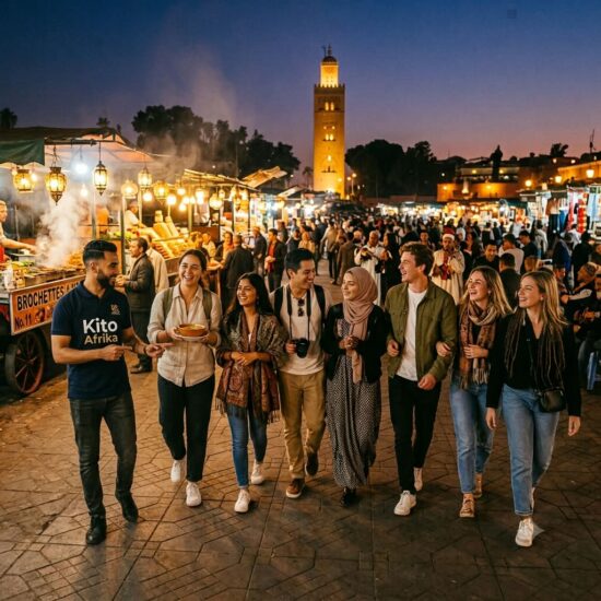 A group of tourists with a Kito Afrika guide exploring the lively Marrakech night market in Morocco, experiencing mild November weather and autumn highlights of the city's food and culture.